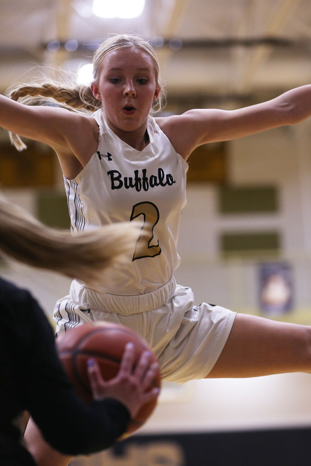 Kendall Tietjen leaps several feet into the air to block the Thermopolis throw in